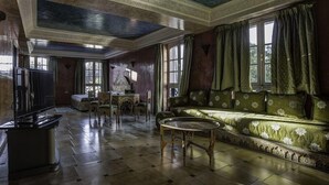A room with a sofa, a table, and a television. - Batha (Fes)