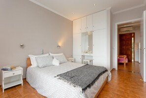 A bedroom with a large bed, a nightstand, a wardrobe, and a mirror. - Villa Katerina - Five Bedroom Villa, Sleeps 10 (Nisaki)