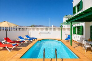 A heated pool, sun loungers