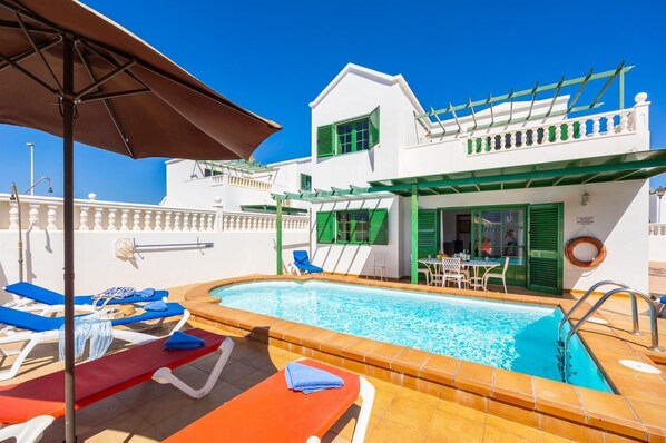 A heated pool, sun loungers
