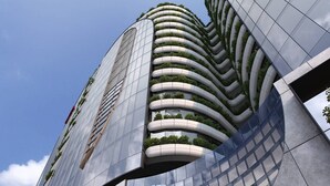 A modern building with a curved facade and multiple balconies.