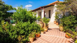 A white house with a tiled porch, surrounded by potted plants and a pool. - Villa Maro Large Private Pool, A/C, WiFi (Kefalas)