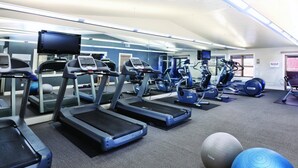 A gym with treadmills, exercise balls, and a television screen. - Beautiful Steamboat Springs Resort (Steamboat Springs)