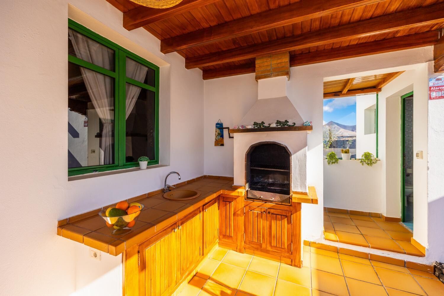 A kitchen with a wooden counter, a sink, and a built-in grill.