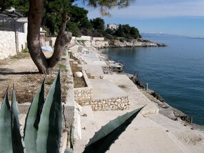 Stroll along the walkway to the ocean, where steps and a railing ensure a safe passage.