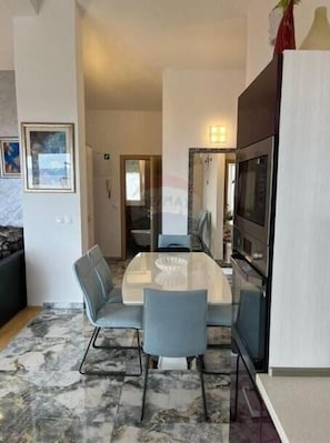 Enjoy meals in this dining area with a glass-top table and comfortable seating for four.