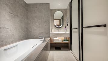 Suite, 1 Bedroom (Living Area) | Bathroom | Rainfall showerhead, designer toiletries, hair dryer, bathrobes