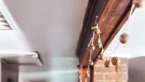 A narrow hallway with a brick wall and a wooden door frame. - The Attic: 2br - 1bth - 4 guests (Champaign)