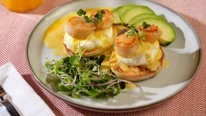 A plate with eggs Benedict, avocado slices, and a glass of orange juice on a tablecloth. - Plan Your Escape to the Cottage! Minutes to Mystic, Connecticut. This pet-friendly retreat has a private fenced-in rear garden patio. Your stay includes organic breakfast, firepit, hammock, and onsite hiking trails. Up to 2 well-behaved pets welcome! (Ledyard)