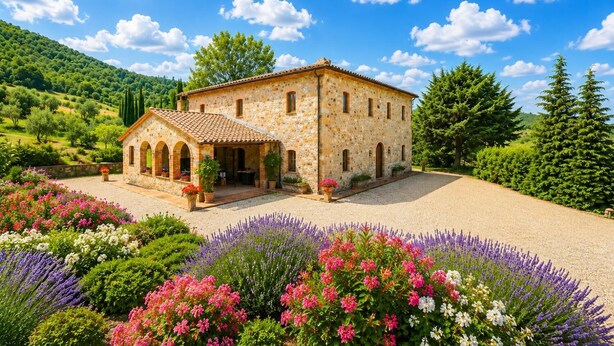 A stone building with a tiled roof, surrounded by a gravel driveway and colorful flower beds. - Villa Il Giulione Large Private Pool, WiFi (Acquapendente)