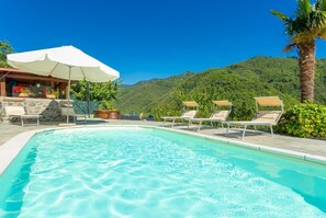 A heated pool, sun loungers