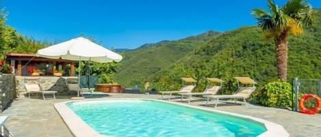 A heated pool, sun loungers