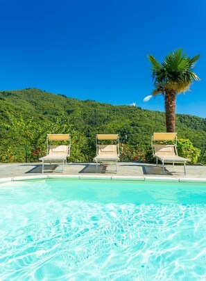 A heated pool, sun loungers