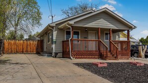 A single-story house with a porch, a front yard with mulch, and a wooden fence. - Cozy and Budget Friendly Single Bedroom in Denver (Denver)