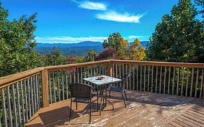 Enjoy a serene view from this outdoor space with a table and chairs.