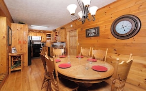 Enjoy meals together at the round dining table, surrounded by a classic ceiling and warm decor.