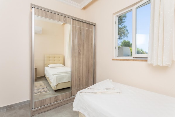 Un dormitorio con una cama, un armario y una ventana.