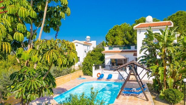 A pool area with a swing, lounge chairs, and a building with a tiled roof. - Villa Charoula Tria Large Private Pool, A/C, WiFi (Polis)