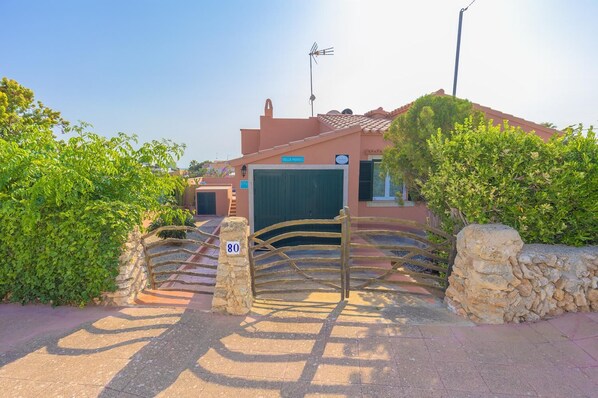 A villa named "Villa Marias" with a gated entrance, stone walls, and a clear sky. - Villa Mares - Three Bedroom Villa, Sleeps 6 (Cala en Porter)