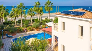 A residential building with a swimming pool, solar panels, and a view of the sea. - Villa Jan Lui - Four Bedroom Villa, Sleeps 8 (Argaka)