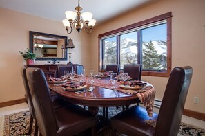 Gather around the elegant dining table where mountain vistas frame every meal, creating unforgettable moments with those you love most. - RA513 | Newly Listed | Amazing Views | Winter Shuttle | Pool | Hot Tubs (Steamboat Springs)