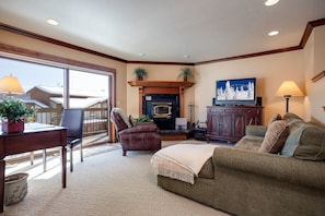 Settle into your private living room, where a cozy fireplace, plush seating, and TV create the perfect spot for unwinding after mountain adventures. - RA513 | Newly Listed | Amazing Views | Winter Shuttle | Pool | Hot Tubs (Steamboat Springs)