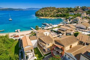 A coastal residential area with houses, a marina, and a beach.