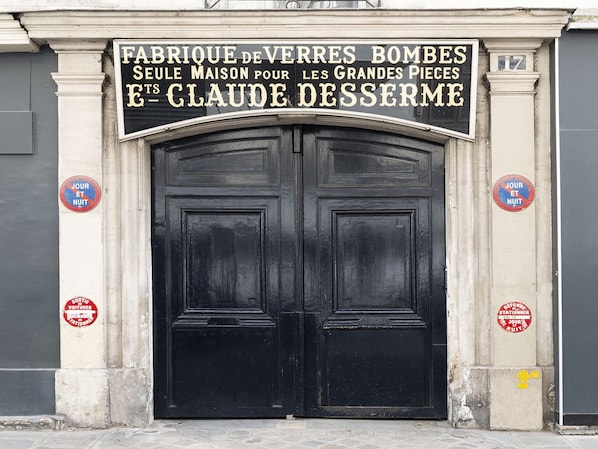 A black double door with a sign above it.