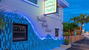 A building with a sign reading "Boutique Beach Retreat."