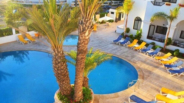 A pool area with lounge chairs and palm trees. - Atlantic Palm Beach Aparthotel 5170 (Agadir)