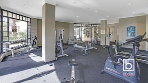 A gym with various exercise equipment, large windows, and a treadmill. - Ocean views  Apartment within Resort - Star of the Sea - Heated Pool (Terrigal)