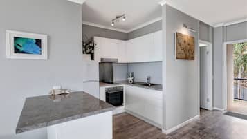 Superior Apartment, 1 King Bed, Ocean View | Private kitchen | Fridge, microwave, oven, stovetop