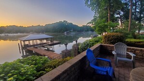 A lakeside deck with a gazebo, lounge chairs, and a grill area. - Updated Lakefront Home w/new Hot Tub & deep water dock, Sleeps 12. (Mooresville)