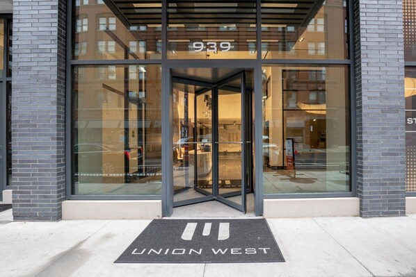 Welcome to UNION WEST, a contemporary building with a sleek entrance featuring a revolving door and a distinctive address.