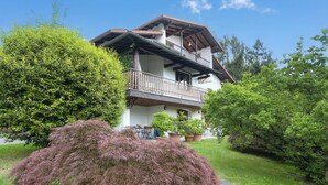 A two-story house with a balcony, surrounded by lush greenery. - La Verbanina 2 - Lake Maggiore Views Duplex for 4, Ghiffa, Italy (Ghiffa)