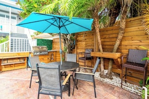 Enjoy al fresco dining on the patio with a grill station and comfortable seating for four.