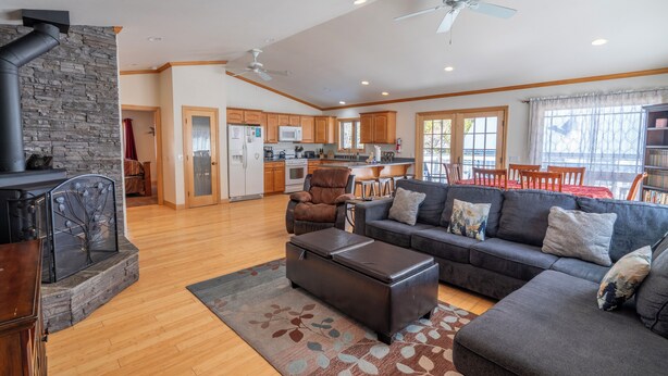 A spacious living room with a fireplace, a sofa set, and a dining area with wooden furniture. - Johnson Suite 2- Walk to both June and Gull Lakes, only 1.5 miles to June Mtn Ski Area (June Lake)