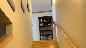 A wooden staircase with a handrail, leading to a bookshelf at the top. - Johnson Suite 2- Walk to both June and Gull Lakes, only 1.5 miles to June Mtn Ski Area (June Lake)