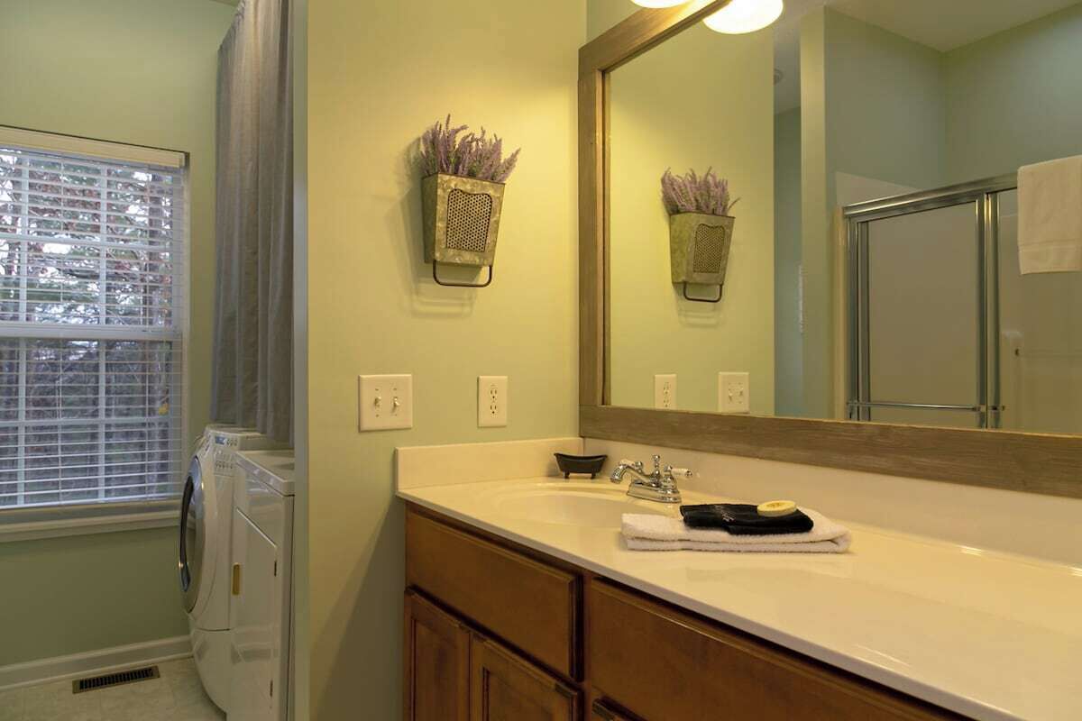 Main Level Foyer Bathroom with Shower and Laundry Area