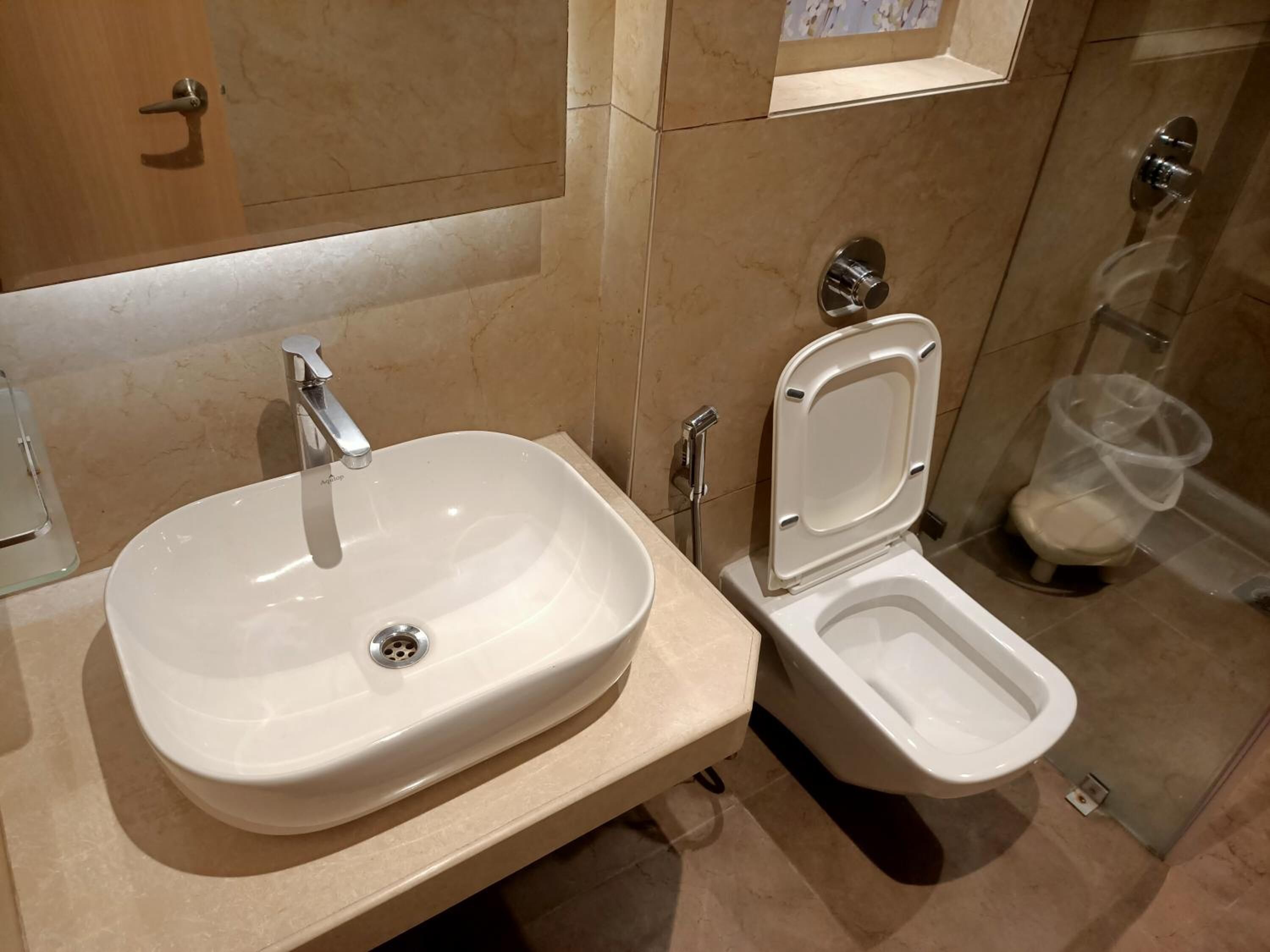 Egy fürdőszoba, amelyben mosdókagyló és WC található.