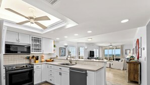 A modern kitchen with a central island, a dishwasher, and a microwave.