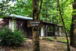 A cabin labeled 'GETAWAY HOUSE' surrounded by trees. - Getaway House at Avenwood Cabins (new straitsville)
