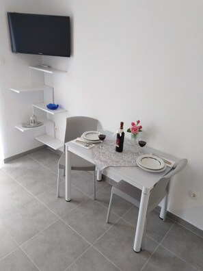 Enjoy meals in this stylish dining area with a flat-screen TV and comfortable seating for two.