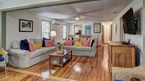 A spacious living room with two sofas, a coffee table, and a wooden cabinet. - Pier Heaven 6031abc 9 Bedroom Home by RedAwning (Rockport)