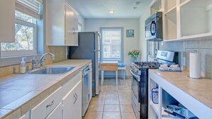A kitchen with a sink, stove, refrigerator, and cabinets. - Muizenberg 6031rpb 3 Bedroom Home by RedAwning (Rockport)