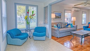 A living room with a blue sofa, two blue armchairs, a grey sofa, and a coffee table. - Muizenberg 6031rpb 3 Bedroom Home by RedAwning (Rockport)