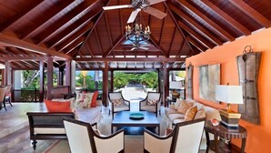 A spacious indoor area with a high ceiling, a central seating arrangement, and a view of the outdoors. - Villa Alila  Summer Promotion | Near Ocean - Located in  Tropical Sandy Lane with Private Pool (Holetown)