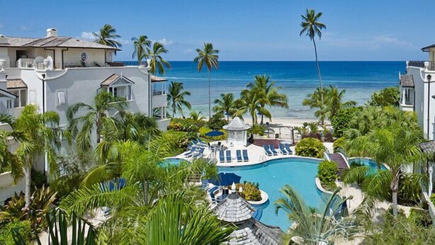 A resort with a pool, palm trees, and a view of the ocean. - Schooner Bay 108 - Condo Chilterns | Beach Front - Located in  Magnificent St. Peter with Concierge Services (St. Peter)