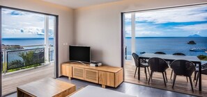 Enjoy ocean views from the large window, with a flat-screen TV and dining area for meals with a view.