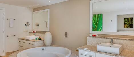 A modern bathroom with a freestanding bathtub, a large mirror, and a vanity with a sink.